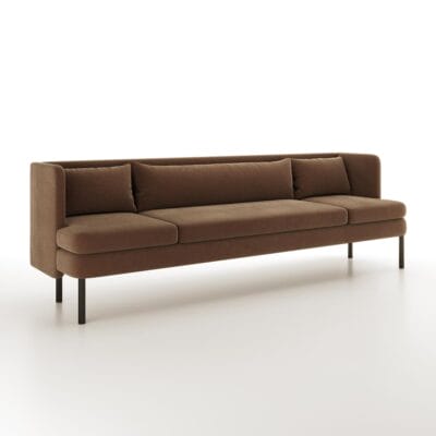 The Alden Sofa from Jamie Stern features a sheltering high back and metal legs.