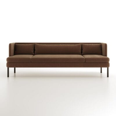 The Alden Sofa from Jamie Stern features a sheltering high back and metal legs.