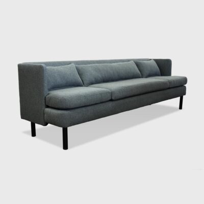 The Alden Sofa from Jamie Stern features a sheltering high back and metal legs.