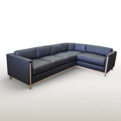 The Bain Sectional is a sophisticated piece that perfectly balances contemporary style with timeless comfort. The exposed wood detailing on the arms, legs and apron subtly contrasts the precise upholstery of the frame and cushions. These many features work together seamlessly to create a rich medley of tactile and aesthetic beauty in a sectional unlike any other.