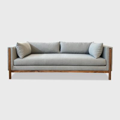 curved back sofa with exposed wood