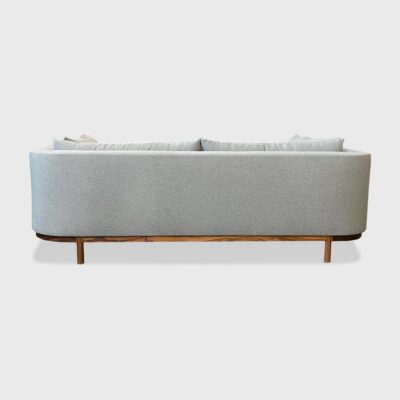 curved back sofa with exposed wood
