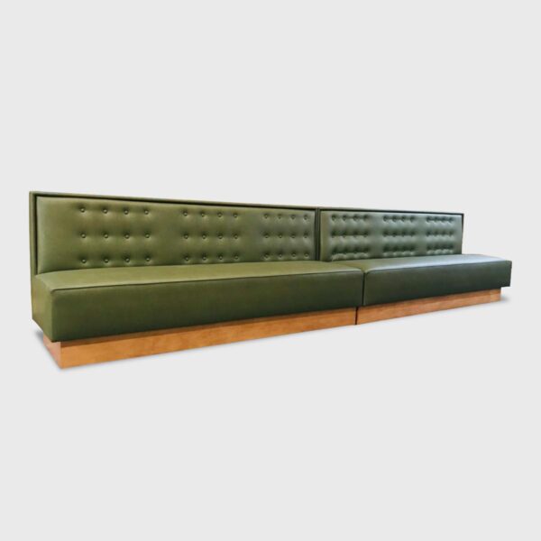 The Bryne Banquette features a tight upholstered seat and back with button detail
