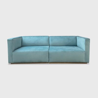The Damien Sofa from Jamie Stern features a tight back with welt detailing and recessed wood base.
