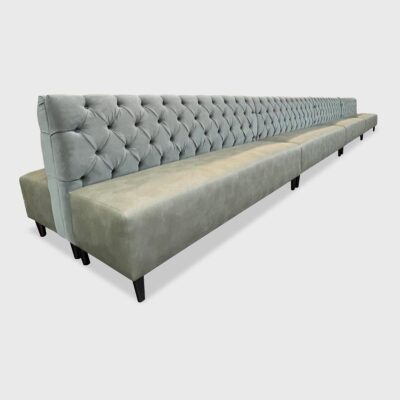 This sleek double-sided banquette features a tight seat, diamond tufted inback and tapered wood legs.