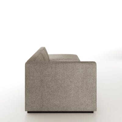 The Elias is a modular sofa featuring a tight back with welt detailing and recessed wood base