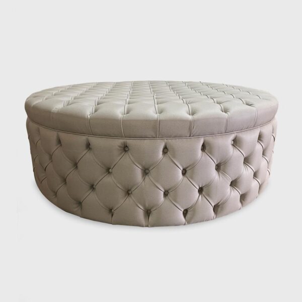 The Gabrielle is a round ottoman from Jamie Stern featuring diamond tufting on all sides