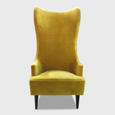 tall wingback chair in yellow velvet by Jamie Stern