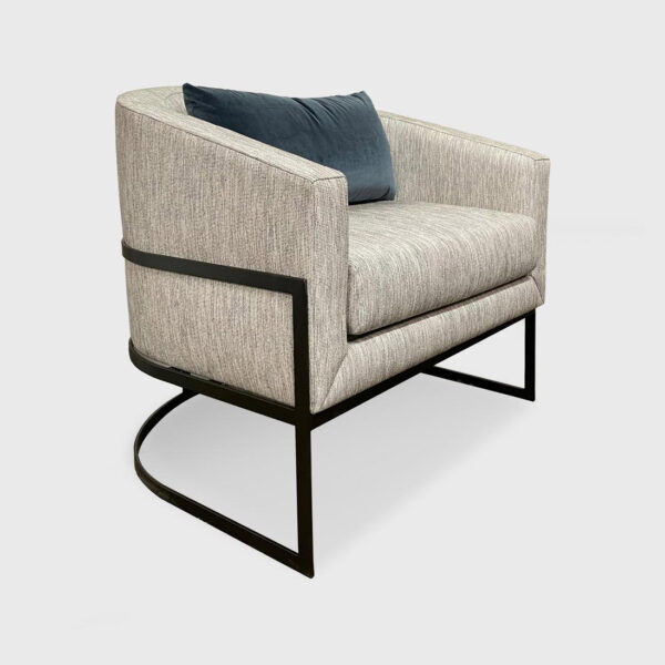 Hanna Lounge Chair from Jamie Stern features a tight back, loose seat with a waterfall edge and metal base.