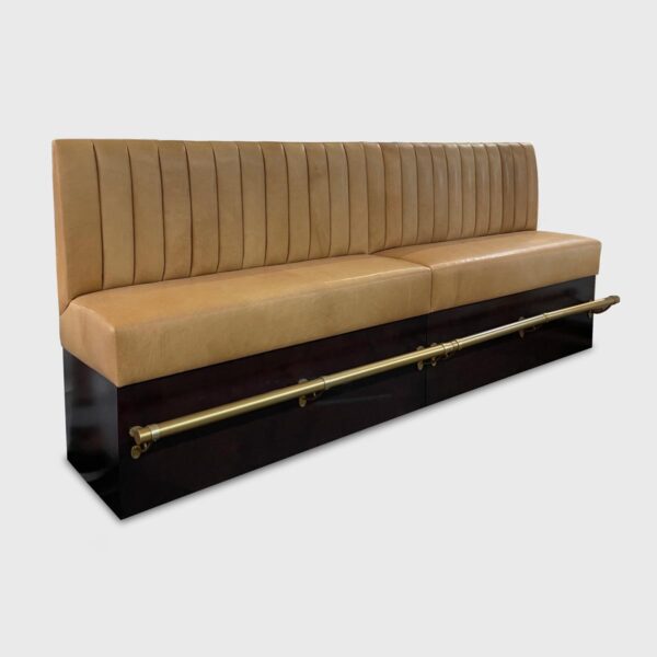 The Milford is a classic banquette built in two pieces and ganged together, resting on a recessed wood base, and made remarkable by its metal foot rest.