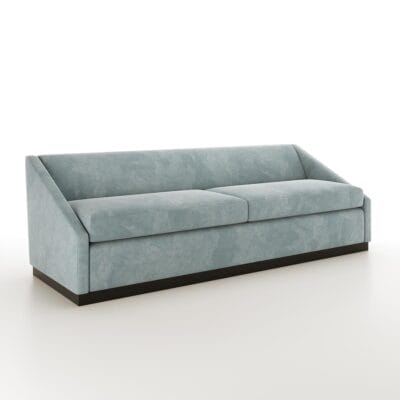 The Roan baby blue sofa from Jamie Stern features dramatically sloped arms and a wood plinth base