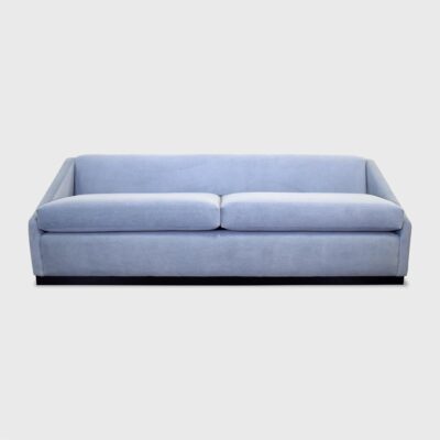 The Roan Sofa from Jamie Stern features dramatically sloped arms and a wood plinth base