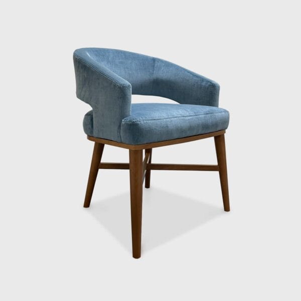 The Rory is a classic barrel dining chair featuring a tight seat and back with round tapered legs and wood "X" stretcher.