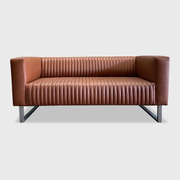 The Sloane Sofa features a vertical channeled seat and back between two sturdy arms. It is an unforgettable sofa in both appearance and comfort.