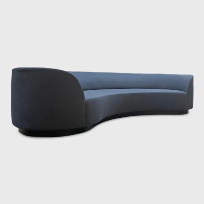 The Wescott is a curved sofa with a recessed wood plinth base from Jamie Stern