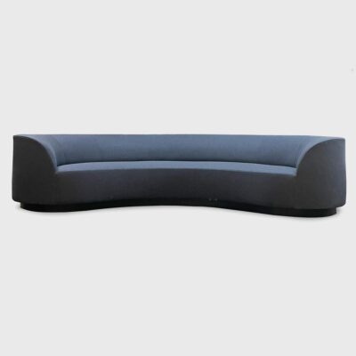The Wescott is a curved sofa with a recessed wood plinth base from Jamie Stern