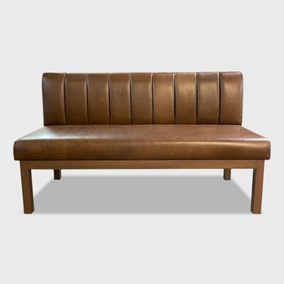 The Zoila Banquette features a tight seat and back, vertical channeling on its inback and a finished wood base. This piece is upholstered in Jamie Stern's Antiquity Brush leather.